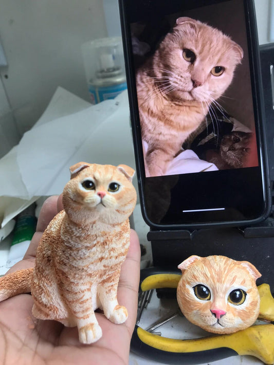 two cat figurines